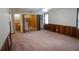 A spacious living room boasts paneled walls, neutral carpet, and closet doors at 1341 Timbercrest Ct, Lawrenceville, GA 30045