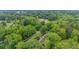 An aerial view captures the wooded area, private driveway and surrounding neighborhood at 1541 Eldonlas Ct, Stone Mountain, GA 30087