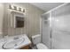 Clean bathroom with walk-in shower and sink with vanity and decorative wallpaper at 1541 Eldonlas Ct, Stone Mountain, GA 30087