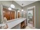 Bathroom with a long marble vanity, a large mirror, wooden cabinets, and toilet in the back at 1541 Eldonlas Ct, Stone Mountain, GA 30087