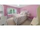 Bedroom with a bed, carpeted floor, floral curtains, and plenty of natural light at 1541 Eldonlas Ct, Stone Mountain, GA 30087