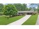 Charming home with a long driveway and lush green lawn at 1541 Eldonlas Ct, Stone Mountain, GA 30087
