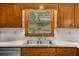View of a stainless steel sink with wooden cabinetry and a window at 1541 Eldonlas Ct, Stone Mountain, GA 30087