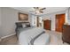 Comfortable main bedroom featuring a ceiling fan, ensuite bathroom, and natural light from the windows at 1541 Eldonlas Ct, Stone Mountain, GA 30087