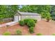 Backyard shed with garage door is nestled in the trees with a pathway at 1541 Eldonlas Ct, Stone Mountain, GA 30087