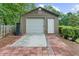 A large shed includes a garage door, standard door, concrete pad and landscaped bed at 1541 Eldonlas Ct, Stone Mountain, GA 30087