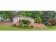 A tan shed in the backyard offers plenty of storage space with an additional garage door at 1541 Eldonlas Ct, Stone Mountain, GA 30087
