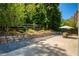 Backyard patio with a stone retaining wall and a beautiful view of the greenery at 340 Monivea Ln, Roswell, GA 30075