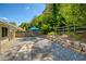 A backyard patio setting features an outdoor table and stone landscaping at 340 Monivea Ln, Roswell, GA 30075