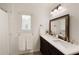 Bathroom with marble countertops, double sinks, framed mirror, and modern lighting at 340 Monivea Ln, Roswell, GA 30075