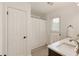 This bathroom features a single sink with matching white marble countertops and backsplash at 340 Monivea Ln, Roswell, GA 30075