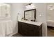 Stylish bathroom featuring a double sink vanity, framed mirror, and modern fixtures at 340 Monivea Ln, Roswell, GA 30075