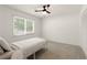 Clean bedroom with carpet, ceiling fan, and ample natural light from the window at 340 Monivea Ln, Roswell, GA 30075