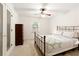 Cozy bedroom features a wrought-iron bed frame, ceiling fan and natural light at 340 Monivea Ln, Roswell, GA 30075