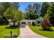 Inviting single-story home featuring a lush front lawn, mature trees, and a concrete driveway leading to the entrance at 340 Monivea Ln, Roswell, GA 30075