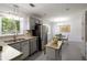 Well-lit kitchen featuring stainless steel appliances and stylish grey cabinetry with backyard views at 340 Monivea Ln, Roswell, GA 30075