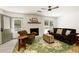 Warm living room featuring a fireplace, comfortable sofa, and a view to the landscaped backyard at 340 Monivea Ln, Roswell, GA 30075