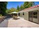 An outdoor patio features a dining table and an umbrella for shade at 340 Monivea Ln, Roswell, GA 30075