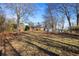 Extensive grassy backyard featuring mature trees and a storage shed, ideal for outdoor activities at 7427 Hollis Rd, Douglasville, GA 30135