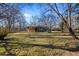 Expansive, grassy backyard features mature trees, creating a serene outdoor retreat at 7427 Hollis Rd, Douglasville, GA 30135