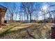 View of the backyard with a storage shed surrounded by trees, offering outdoor storage at 7427 Hollis Rd, Douglasville, GA 30135