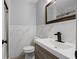 Bathroom with marble backsplash, gray walls, and modern fixtures offers bright and stylish design at 7427 Hollis Rd, Douglasville, GA 30135