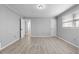 Large bedroom with wood floors, gray walls, and white trim provides a calm and soothing space at 7427 Hollis Rd, Douglasville, GA 30135