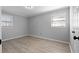 Bedroom with wood floors, gray walls, and white trim provides a calm and soothing space at 7427 Hollis Rd, Douglasville, GA 30135