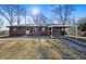 Charming brick home with a carport, lush lawn and classic design creating a welcoming curb appeal at 7427 Hollis Rd, Douglasville, GA 30135