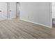 Hallway with wood floors and neutral walls has multiple doors leading to different parts of the house at 7427 Hollis Rd, Douglasville, GA 30135