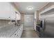 Well-lit kitchen features white cabinets, stainless steel appliances, new countertops, and a modern aesthetic at 7427 Hollis Rd, Douglasville, GA 30135