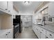 Bright kitchen with white cabinetry, granite countertops, stainless steel appliances, and modern fixtures at 7427 Hollis Rd, Douglasville, GA 30135