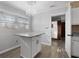 Bright eat-in kitchen featuring a new kitchen island with granite countertop, cabinets, and modern lighting at 7427 Hollis Rd, Douglasville, GA 30135