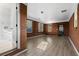 Bright living room with hardwood floors, brick walls, and large windows providing natural light at 7427 Hollis Rd, Douglasville, GA 30135