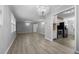Open-concept living area with hardwood floors and a chandelier, flowing into a well-equipped kitchen at 7427 Hollis Rd, Douglasville, GA 30135