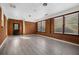 Spacious living room featuring wood paneled walls, hardwood floors, and lots of natural light at 7427 Hollis Rd, Douglasville, GA 30135