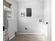 Utility room with wood floors and gray walls offers simple modern design at 7427 Hollis Rd, Douglasville, GA 30135