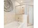 Elegant bathroom with a soaking tub, glass-enclosed shower, and tiled walls at 855 Peachtree Ne St # 2203, Atlanta, GA 30308