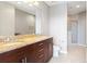 Bathroom featuring double vanity, granite countertops, and a glass-enclosed shower at 855 Peachtree Ne St # 2203, Atlanta, GA 30308
