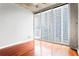 Inviting bedroom with hardwood floors, concrete accents, and floor-to-ceiling windows at 855 Peachtree Ne St # 2203, Atlanta, GA 30308