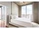 Bright bedroom with city views, hardwood floors, and a modern ceiling fan at 855 Peachtree Ne St # 2203, Atlanta, GA 30308
