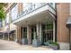Inviting building entrance with planters, clear signage, and modern architectural details at 855 Peachtree Ne St # 2203, Atlanta, GA 30308