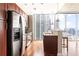 Modern kitchen with stainless steel appliances, granite countertops, and a breakfast bar overlooking the city at 855 Peachtree Ne St # 2203, Atlanta, GA 30308