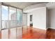 Spacious living room with hardwood floors, neutral paint, and floor-to-ceiling windows at 855 Peachtree Ne St # 2203, Atlanta, GA 30308