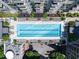 Overhead view of a modern rectangular pool surrounded by lounge chairs and greenery at 855 Peachtree Ne St # 2203, Atlanta, GA 30308