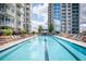 Long pool deck with lounge chairs and manicured landscaping between two high-rise buildings at 855 Peachtree Ne St # 2203, Atlanta, GA 30308