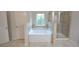 Bright bathroom with a soaking tub and walk-in glass shower at 2289 Overlook Ave, Lithonia, GA 30058