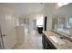 Bathroom featuring a granite vanity with dual sinks, a large mirror and separate tub and shower at 2289 Overlook Ave, Lithonia, GA 30058