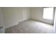 Bedroom featuring plush carpet, a bright window, and a door at 2289 Overlook Ave, Lithonia, GA 30058