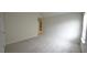 Bright bedroom featuring plush carpet, a bright window, and a door at 2289 Overlook Ave, Lithonia, GA 30058